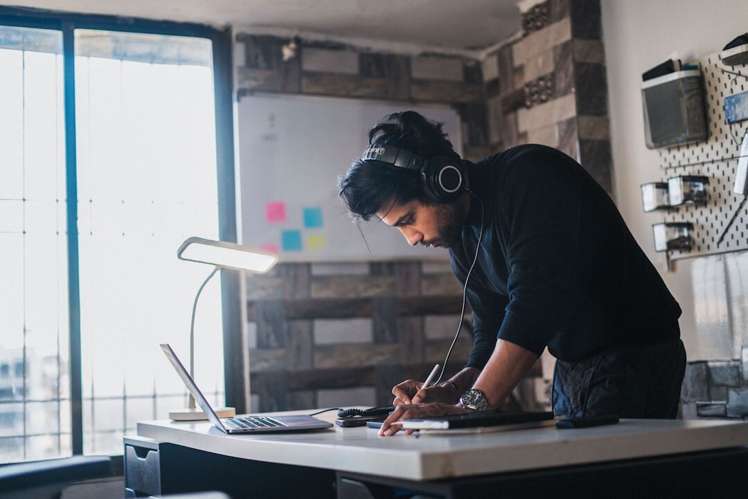 Professional taking detailed notes during a coaching session at a modern desk