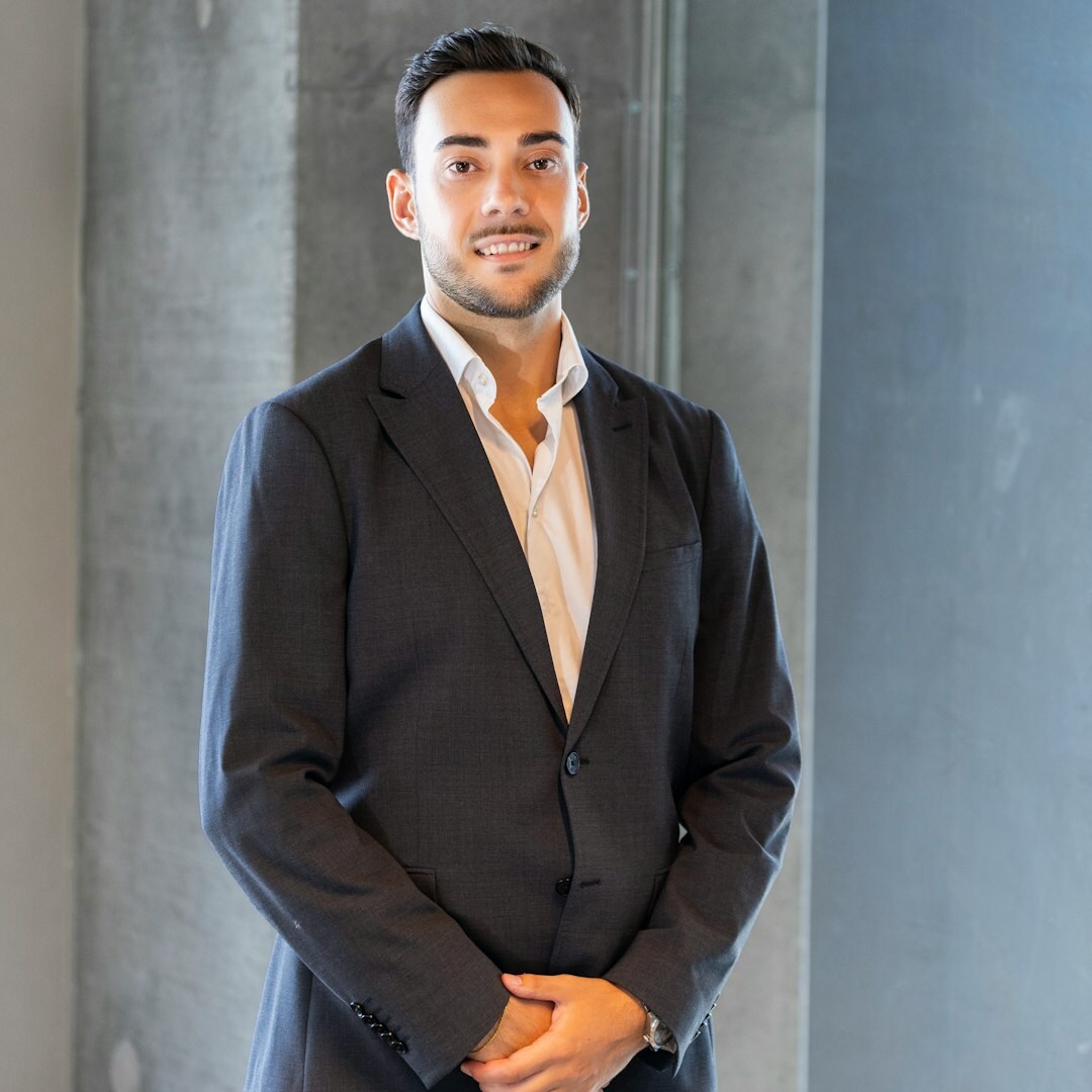 Confident young professional man smiling after completing interview coaching